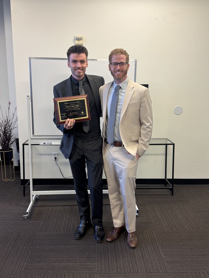 A team member receiving a recognition plaque