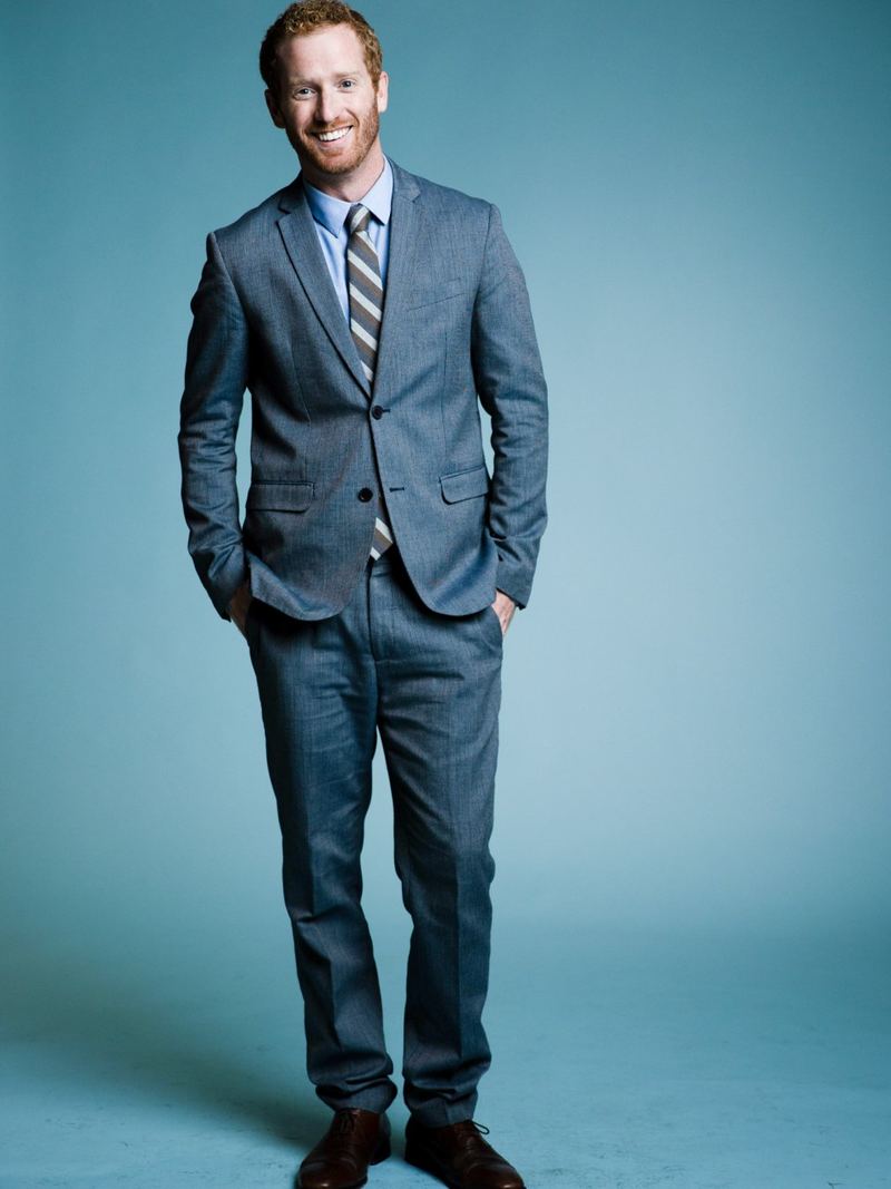 Dustin Harward, CEO of Clarity Acquisitions, standing in a blue suit