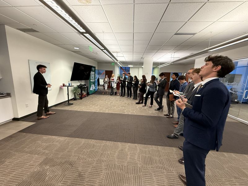 Team members practicing pitches during a training drill